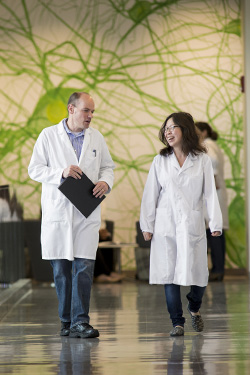 photo of a professor and students walking down a hallway