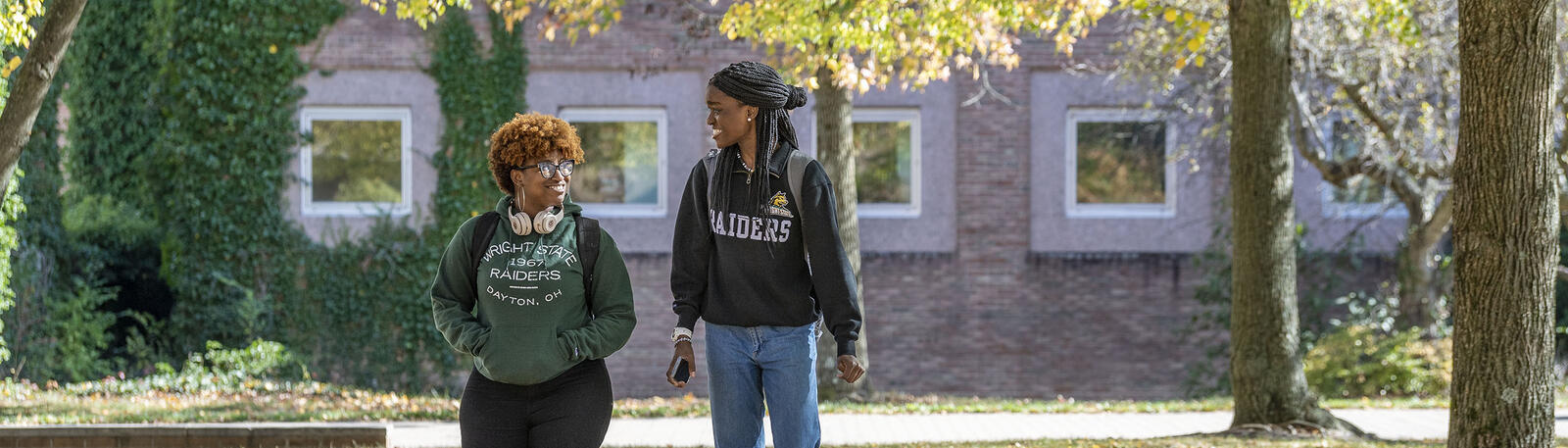 photo of two students walking outside of the math and micro building