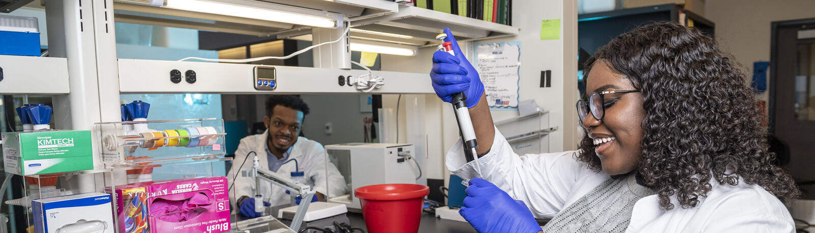 photo of two students working in a lab