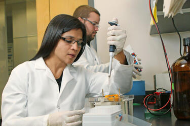 photo of a professor and student working in a lab
